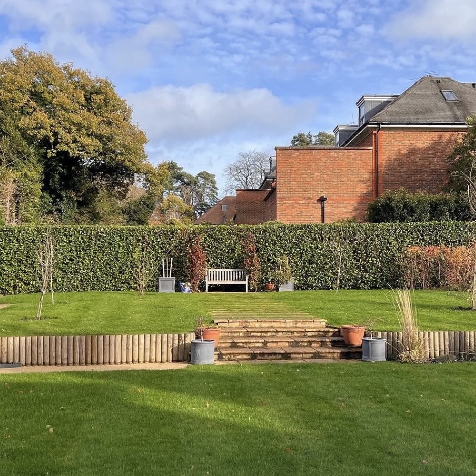 Hand spreading grass seed and topsoil